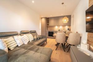 a living room with a couch and a kitchen at Nestzeit in Eben im Pongau