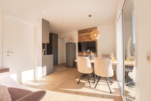 a kitchen and living room with a table and chairs at Nestzeit in Eben im Pongau +29 photos