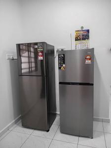 two refrigerators are sitting next to each other at Balqis LN Homestay in Taiping