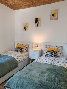 two beds sitting next to each other in a bedroom at Šimun&Jakov in Drinovci