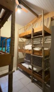 a room with bunk beds in a house at Drop House Hostel in Ubatuba
