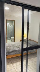 a bedroom with a bed and a mirror at dpto todo limpieza in San Vicente