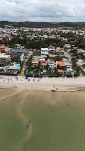 an aerial view of a beach with a group of buildings at Amaliê Pousada in Barra de São Miguel