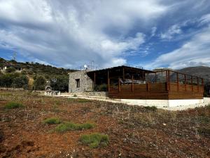 a building on a hill in a field at Small villa with pool DOXA PETRA in Sísion +31 photos