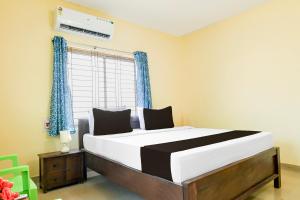 Postel nebo postele na pokoji v ubytování Hotel O Unicorn Guest House