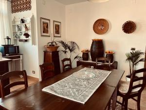 a dining room with a wooden table and chairs at Sand'Ana House B&b in Alghero