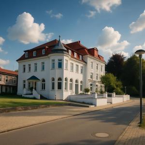 a large white building with a red roof at Seeschloss Hotel Kellersee in Eutin