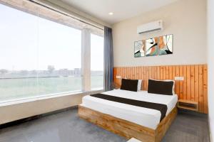 Ένα ή περισσότερα κρεβάτια σε δωμάτιο στο HOTEL O OLIVE HOTEL