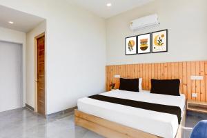 Ένα ή περισσότερα κρεβάτια σε δωμάτιο στο HOTEL O OLIVE HOTEL