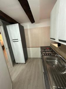 a kitchen with a stove and a sink in it at Flower Home in Crotone