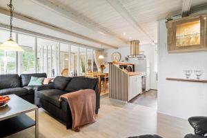 Una sala de estar con un sofá y una cocina. en 30073-Ulfborg-Grastensborgvej-35, en Sønder Nissum
