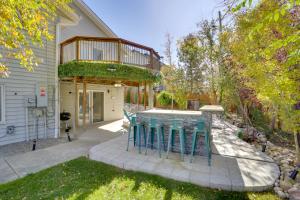 a house with a patio with blue stools at 6 Mi to Barr Lake Apt with Hot Tub Access! in Brighton
