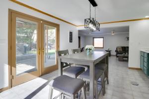 a dining room and living room with a table and chairs at 6 Mi to Barr Lake Apt with Hot Tub Access! in Brighton