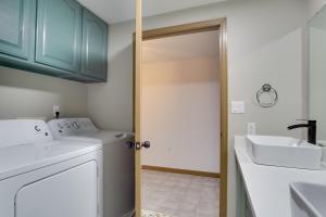 a laundry room with a washing machine and a sink at 6 Mi to Barr Lake Apt with Hot Tub Access! in Brighton +18 photos