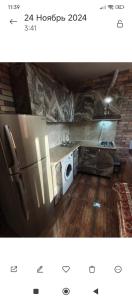 a kitchen with a refrigerator and a washing machine at Dav Home in Vanadzor