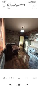 a living room with a couch and a brick wall at Dav Home in Vanadzor