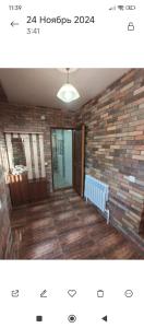 a living room with a brick wall and a light at Dav Home in Vanadzor