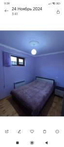 a bedroom with a bed in a blue room at Dav Home in Vanadzor