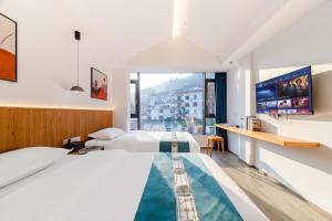 Postel nebo postele na pokoji v ubytování Huang Mountain Wangfeng Hotel + 41 fotografií