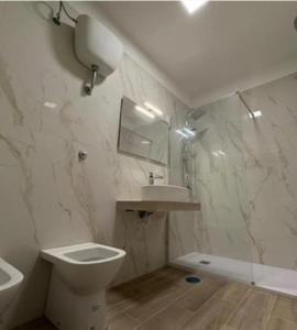 a white bathroom with a toilet and a sink at B&B antonia in SantʼAntonio Abate
