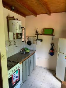 a kitchen with a sink and a stove and a refrigerator at Espacio Kaskai in San Marcos Sierras +16 photos
