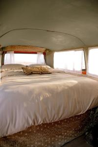 a large white bed in the back of a van at Amazigh van Agafay in Oumnas