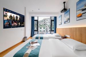 Postel nebo postele na pokoji v ubytování Huang Mountain Wangfeng Hotel