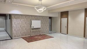 a large room with a wall with a whiteboard at Arzum Hostel in Tashkent
