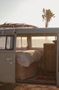 an open door of an rv with a bed in it at Amazigh van Agafay in Oumnas