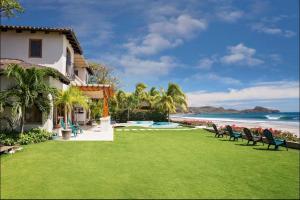 a resort with a lawn with chairs and the beach at Casa Colorados in Tola +17 photos