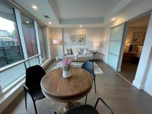 a living room with a table and chairs and a couch at Downtown bright cozy & modern 1 Bedroom in Halifax