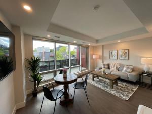 a living room with a couch and a table and chairs at Downtown bright cozy & modern 1 Bedroom in Halifax