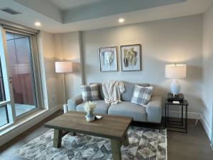 a living room with a couch and a coffee table at Downtown bright cozy & modern 1 Bedroom in Halifax +11 photos