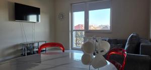 a living room with a table and red chairs at Apartament Srebrny Quick Park Oława in Oława
