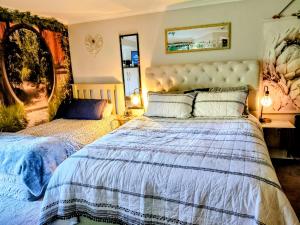 a bedroom with a bed and a mirror at Private Rotorua Hideaway - Pet Friendly BB with Electric Heating in Mourea