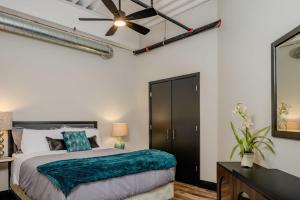 a bedroom with a bed and a ceiling fan at Modern City View 1BR Apartment with Office - free parking in Appleton