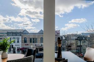 a view of a city from a balcony with a table and chairs at Modern City View 1BR Apartment with Office - free parking in Appleton