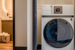 a washer and dryer sitting in a room at Modern City View 1BR Apartment with Office - free parking in Appleton