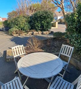 a wooden table and two chairs with a table and two chairs at Ty Heulwen Studio in St. Davids