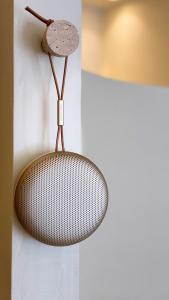 a rattan microphone hanging on a wall at âme casa in Mesochórion