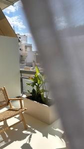 a balcony with a chair and a plant at âme casa in Mesochórion