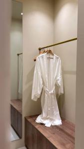 a white shirt on a hanger in a room at âme casa in Mesochórion