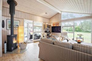 a living room with a couch and a fireplace at SL070-Slagelse-Snerlevej-2 in Slagelse