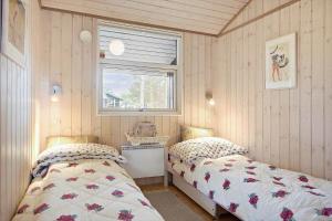a bedroom with two beds and a window at SL070-Slagelse-Snerlevej-2 in Slagelse