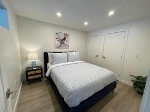 a bedroom with a bed and a night stand with a lamp at Waterfront large 1 BR with 6 appliances & gym in Halifax