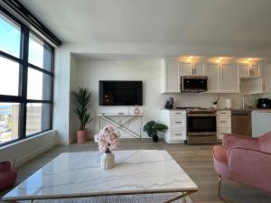 a living room with a table and a kitchen at Waterfront large 1 BR with 6 appliances & gym in Halifax +6 photos