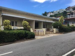 a building on the side of a street at charming 1 bedroom house in Port-of-Spain