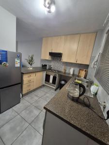 a kitchen with a refrigerator and a counter top at Mlangeni's Rest in Centurion