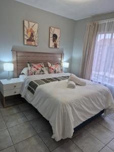 a bedroom with a large bed and a window at Mlangeni's Rest in Centurion
