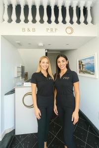 two women in black scrubs standing next to each other at Pantarei Palace in Lettere